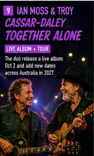 Ian Moss and Troy Cassar-Daley performing acoustic guitars together on warm stage.