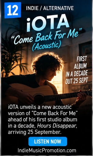 iOTA seated in warm room playing acoustic guitar for Come Back For Me.