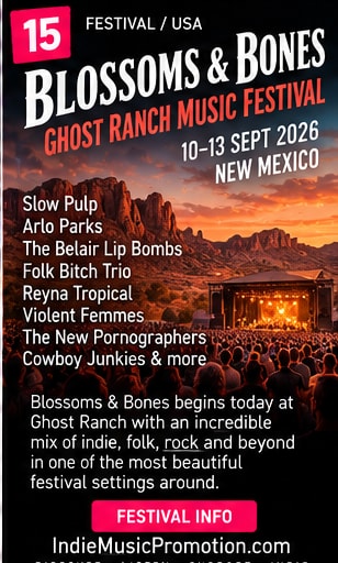 Dramatic red rock canyon cliffs of Ghost Ranch with an outdoor festival stage below.