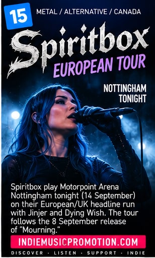 Courtney LaPlante of Spiritbox singing into microphone under blue stage lights at Motorpoint Arena Nottingham.