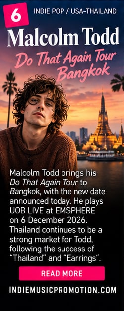 Malcolm Todd in brown sweater with Bangkok temple Wat Arun and sunset skyline in background.